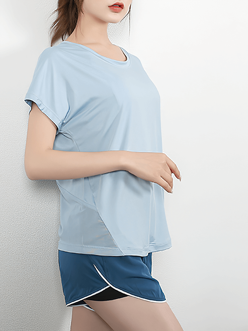 Woman wearing a short sleeves mesh loose yoga t-shirt with breathable fabric and stylish back, perfect for active workouts.